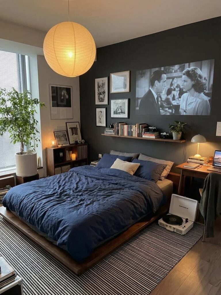 Cozy bedroom with blue bedding, round paper lantern, and movie projected on wall.