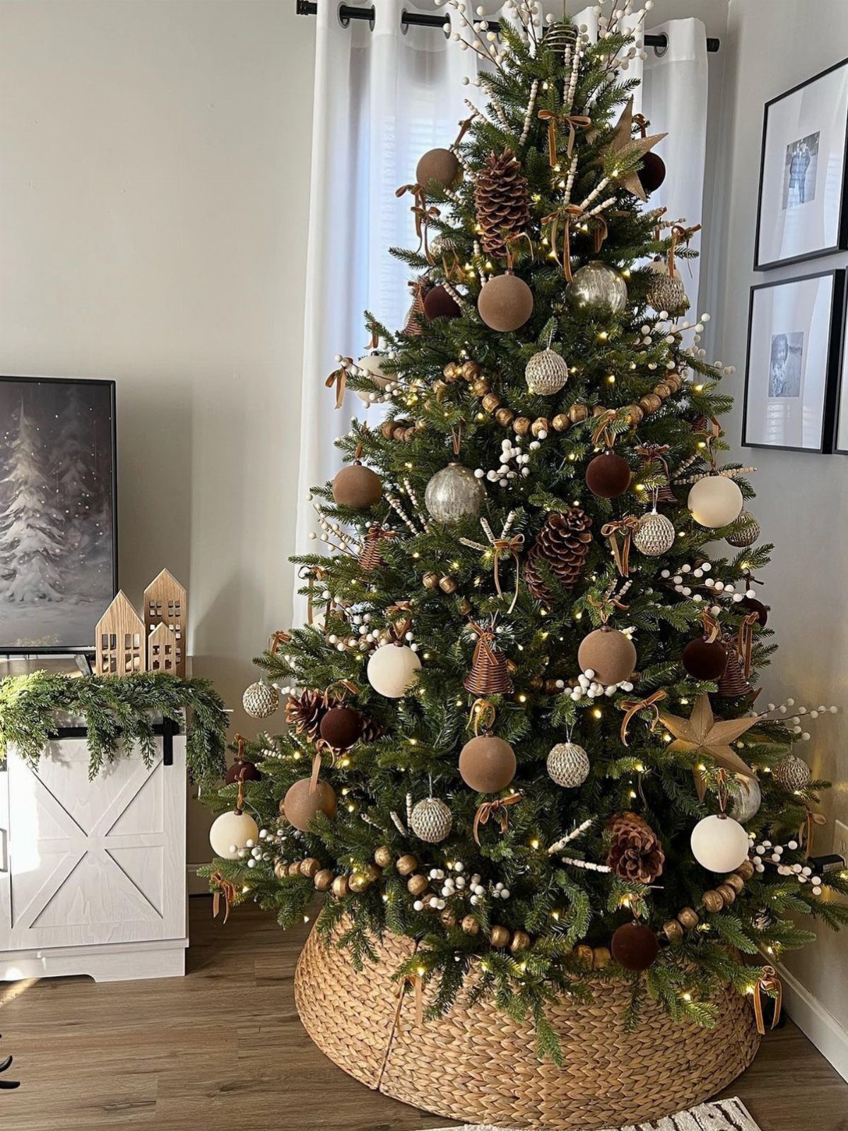 Decorated Christmas tree with neutral ornaments and a wicker basket base in a home.