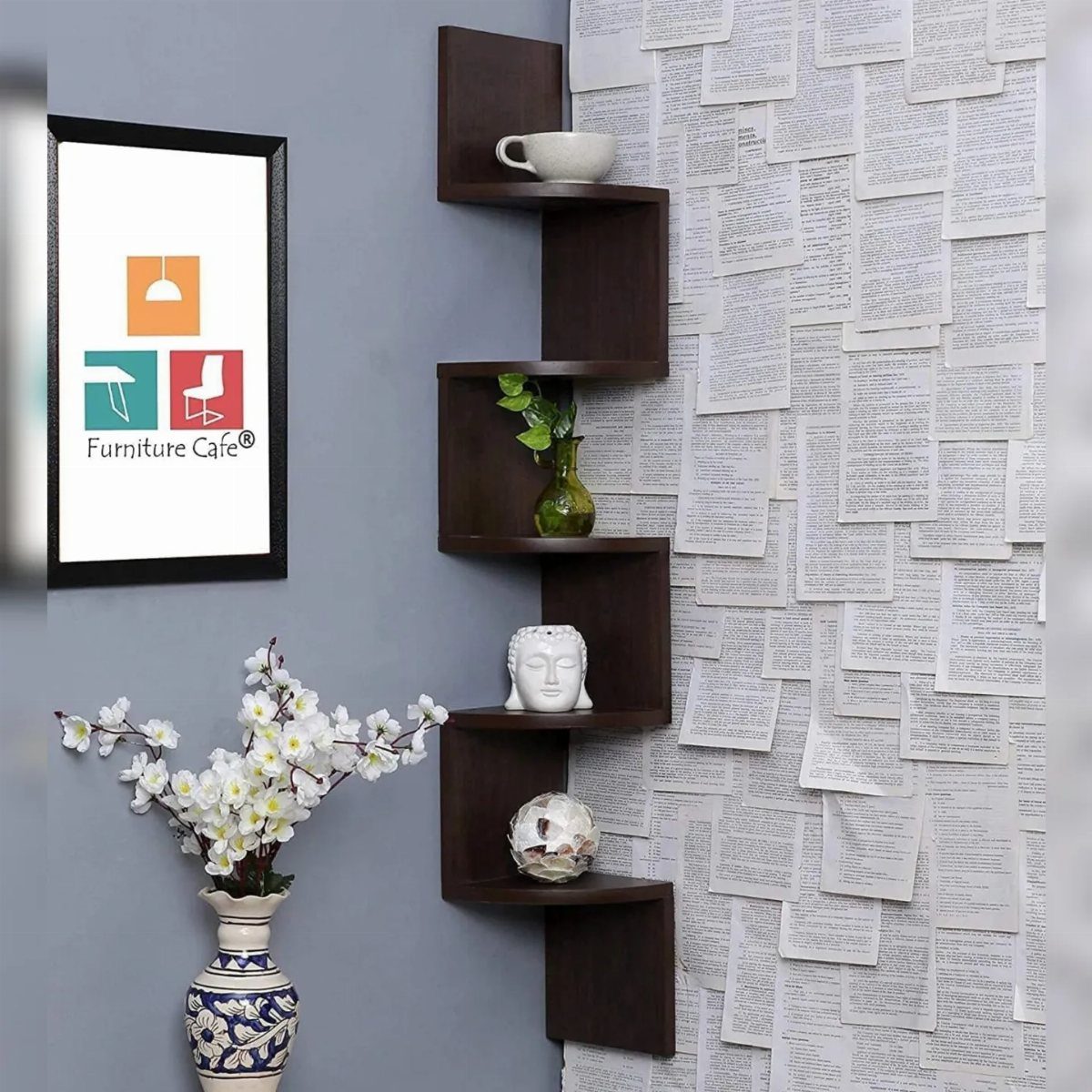 Dark brown zig-zagging tiered wall shelf holding decorative items against a grey wall.
