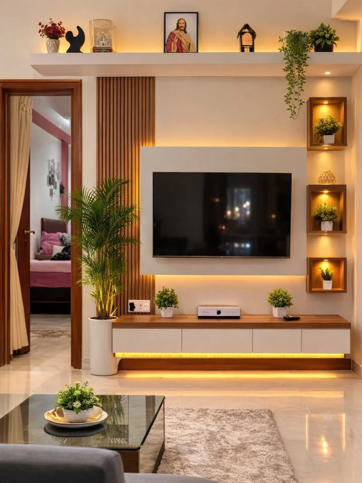 Modern living room wall with vertical wooden paneling, built-in shelves, and a television.